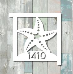 a white starfish with the number forty on it is mounted in a square frame