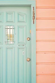 a blue front door with bars on the top and bottom part is painted pale pink