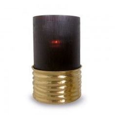 a black and gold candle holder with a red light