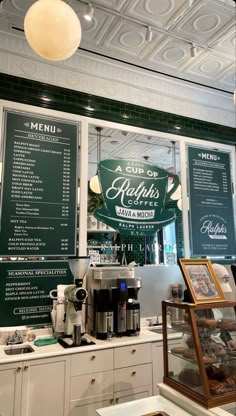 the inside of a coffee shop with menus on the wall and other items displayed