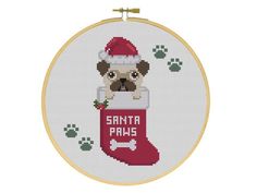 a cross stitch christmas stocking with a dog in it