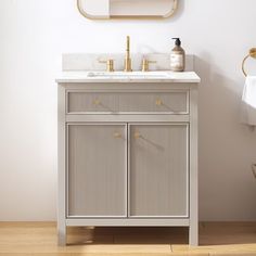 a white sink sitting under a mirror in a bathroom