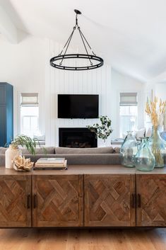 a living room filled with furniture and a flat screen tv mounted to the side of a wall