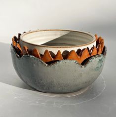 a white and brown bowl sitting on top of a table