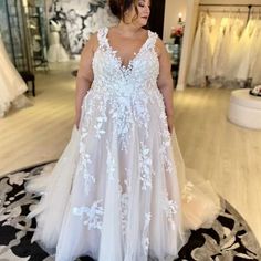 a woman in a wedding dress standing on a rug