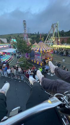 people are riding on the back of a motorcycle at an amusement park