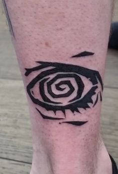 a person with a tattoo on their leg that has an eye drawn on the side