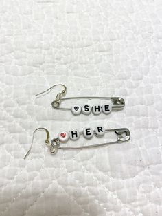 Help your friends and family remember your pronouns with these earrings! Not only your pronouns, but just about anything you want to express.  These are customizable, up to 5 beads per pin/earring.  Select CUSTOM, check Add Personalization and type what you want each earring to say separated by at least one SPACE. Please only use English Alphabetical letters, or which color heart you want. For example: SAM(red heart) THEY(black heart) would make the earrings SAM❤️ and THEY🖤 Please feel free to message me with questions! Color Heart, Colorful Heart, Black Heart, Safety Pin, Red Heart, Jewelry Earrings Dangle, Dangle Drop Earrings, Dangle Earrings, Jewelry Earrings