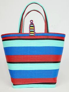 Material: Recycled plastic. Color: Red, blue, sky blue, black. Size: Height 12" Width 14" Use: Grocery, beach, pool... Property: Waterproof, easy to clean. Origin: West Africa. Handwoven bags made from recycled plastics. This bag is waterproof and very easy to clean. This material is very strong and can hold heavy contain. Blue Packable Bags For Vacation, Eco-friendly Red Beach Bag For Daily Use, Eco-friendly Red Beach Bag, Eco-friendly Red Tote Beach Bag, Casual Blue Packable Beach Bag, Blue Plastic Tote Bag, Eco-friendly Blue Beach Bag, Blue Bucket Beach Bag, Blue Recyclable Travel Bags