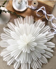 white paper flowers are sitting on a table