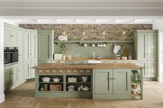 a kitchen with green cabinets and wooden floors