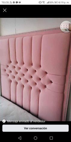 a pink headboard with buttons on the side and an arrow pointing up at it