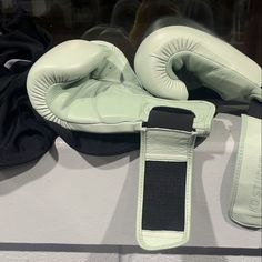 a pair of boxing gloves sitting on top of a counter next to a glove holder