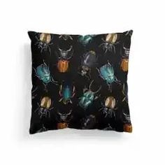 a black pillow with colorful bugs on it