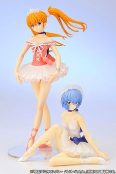 two figurines sitting on the ground next to each other in front of a blue background