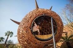 there is a sculpture made out of wicker and has a woman in it on top