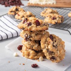 cookies with cranberries and white chocolate chips stacked on top of each other