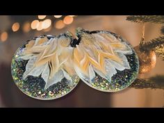 two ornaments hanging from a christmas tree