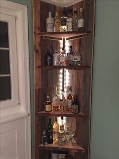 a wooden shelf filled with lots of bottles