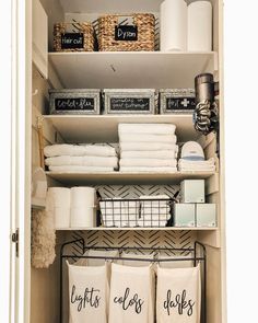 the closet is organized with linens, towels and other household care items in baskets