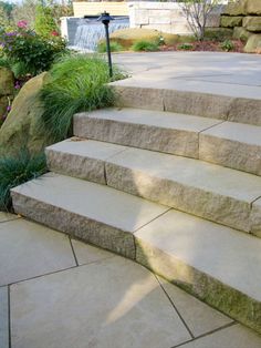 the steps are made of stone and have grass growing on them, along with a lamp post