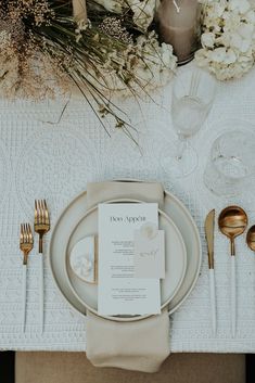 a table set with place settings, silverware and napkins for an elegant dinner