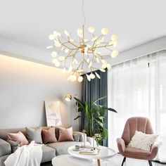 a living room filled with furniture and a chandelier hanging over the top of it