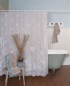 a white bath tub sitting next to a shower curtain