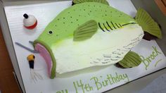 a birthday cake shaped like a fish on top of a table