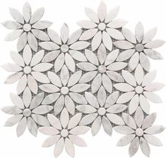 an arrangement of white and gray flowers on a white background