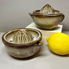 two bowls and a lemon on a table