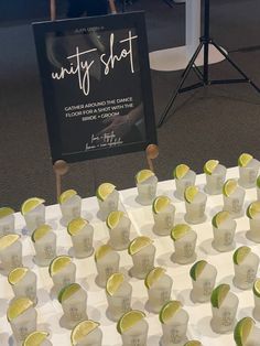 many shots are lined up on a table with a sign in the background that says, minty shot