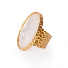 The Statement ring lives up to its name with a stunning large oval stone set in an 18K gold plate over hypoallergenic and nickel-free brass. You won't need to wear any other ring, but the more the merrier, so pair it with some of our dainty rings on the other hand. This ring is perfect for vamping up any look. Details: METAL 18k Gold Plated Over Brass MATERIAL Mother of Pearl SIZE 1.25 in x 1.5 in Please note: Due to the one-of-a-kind nature of the medium, exact colors and patterns may vary slig Gold Oval Dome Ring With Cabochon, Oval Yellow Gold Brass Ring, Elegant Gold Moonstone Ring In Brass, Elegant Brass Dome Ring, Elegant Hammered Rings, Elegant Gold Crystal Ring With Polished Finish, Elegant Brass Rings With Cabochon, Elegant Brass Moonstone Ring, Gold Jewelry With Large Oval Cabochon Stone