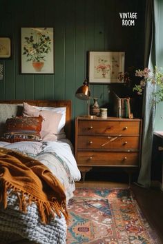 a bedroom with green painted walls and an antique dresser in the corner next to it