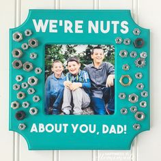 a blue frame with an image of two boys and the words, we're nuts about you, dad