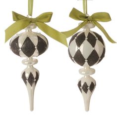 two black and white ornaments with green bows