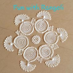 some white doily on top of a brown paper with the words fun with rangoli