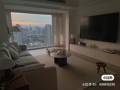 a living room with a large window overlooking the city