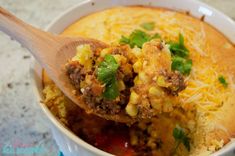 a spoon full of food sitting in a bowl