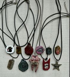 an assortment of necklaces with different designs on them