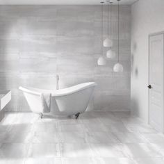 a white bath tub sitting inside of a bathroom