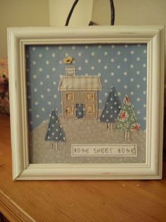 there is a picture frame with a house and trees on it that says home sweet home