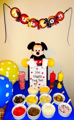 a mickey mouse birthday party with food and decorations