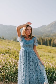 Elevate your style with our EXCLUSIVE Seaside Brunch Dress. In a beautiful dusty blue, our midi dress features a delicate floral eyelet overlay and a double tie for a touch of elegance. The square neck adds a unique touch to this one-of-a-kind design, exclusively available at One Loved Babe. Available in sizes XS-6XL for all to enjoy. Details Midi length Sheer sleeves Lined Invisible zipper enclosure Double tie Square neck Floral eyelet overlay Sizing *Measurements are taken with item hanging an Modest Summer Dresses With Lace Trim, Modest Lace Trim Summer Dress, Modest Blue Midi Dress For Garden Party, Blue Short Sleeve Lace Dress For Summer, Modest Spring Lace Dress, Modest Lace Dress For Spring, Blue Lace Dress For Spring, Modest Light Blue Summer Dress, Light Blue Lace Dress For Summer