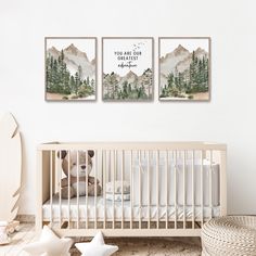 a baby crib with two pictures on the wall