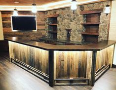 an empty bar with stone walls and wood flooring