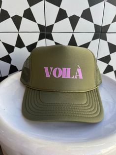 Exclusively from Passport Habits, our newest version of trucker hats have your favorite greetings from your favorite destinations! Voila means "There it is" in French. What a wonderful way to express your happiness in whatever comes your way! Available in yellow, red, navy blue, black, turquoise and army green Hats have a mesh backing and are adjustable. Green Snapback Trucker Hat For Vacation, Summer Green Trucker Hat With Letter Print, Green Summer Trucker Hat With Letter Print, Green Trucker Hat With Letter Print For Summer, Green Trucker Hat With Letter Print, Green Trucker Hat With Letter Print And Curved Bill, Green Letter Print Trucker Hat For Beach, Green Letter Print Trucker Hat For The Beach, Green Trucker Hat With Letter Print For The Beach