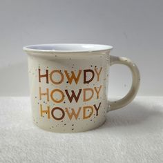 a white coffee mug with the words howdy howdy howdy on it