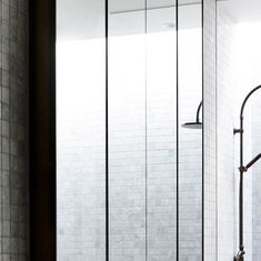 a bathroom with a glass shower door next to a toilet