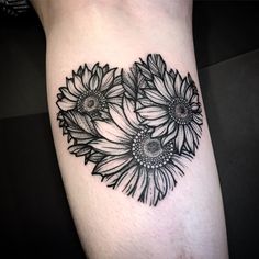 black and white sunflowers tattoo on the left thigh, with an intricate design